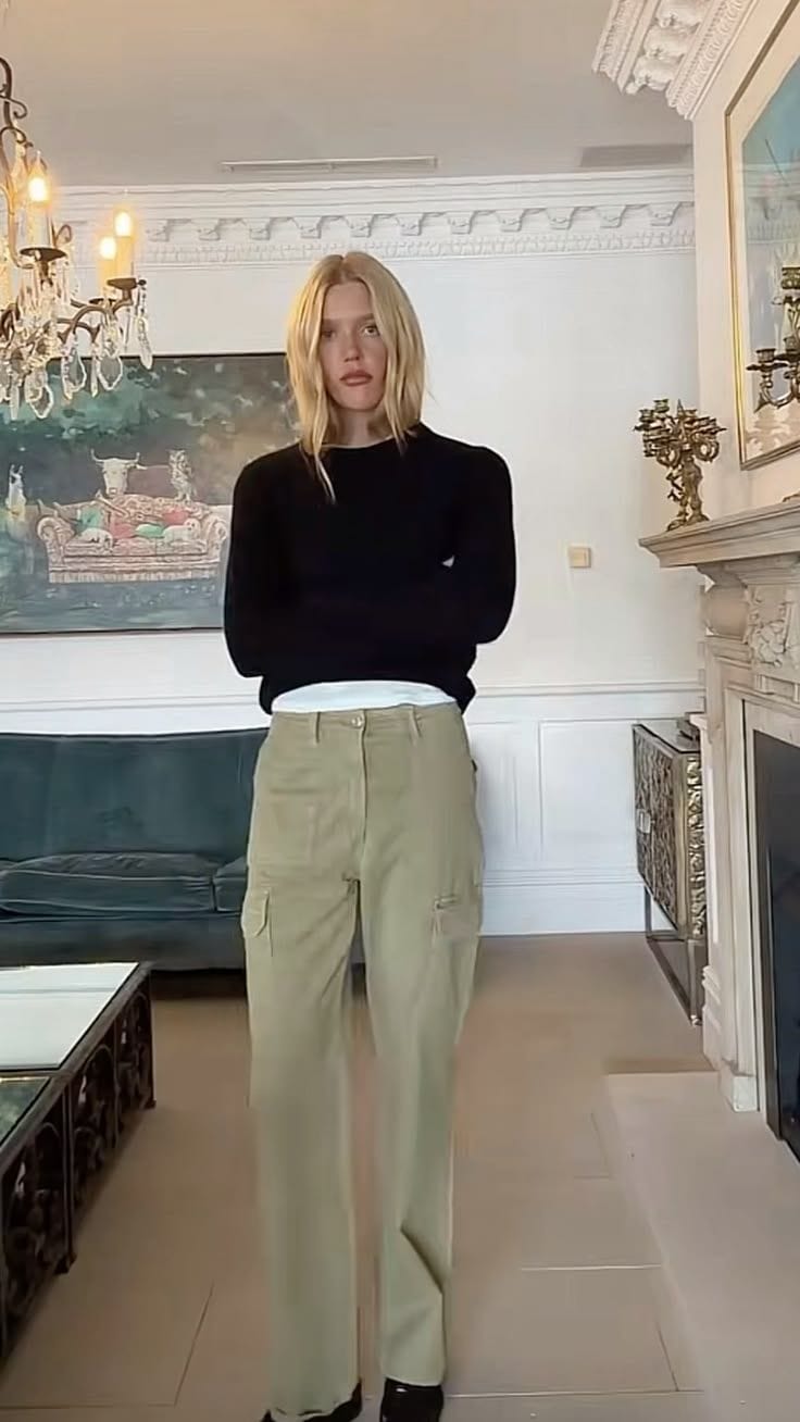 Green pants + black sweater + contrast tee