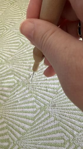 Repairing scratched upholstery with a felting needle