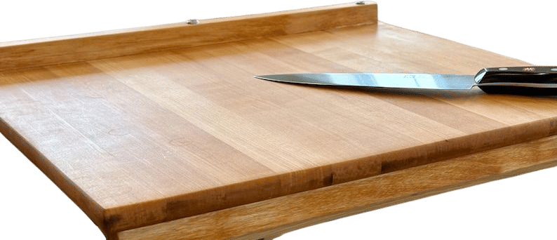 A wood cutting board with a lip that lives on the counter