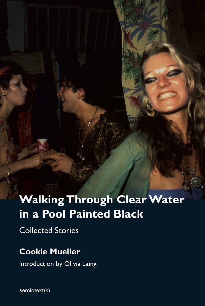 cookie mueller -- walking through clear water in a pool painted black