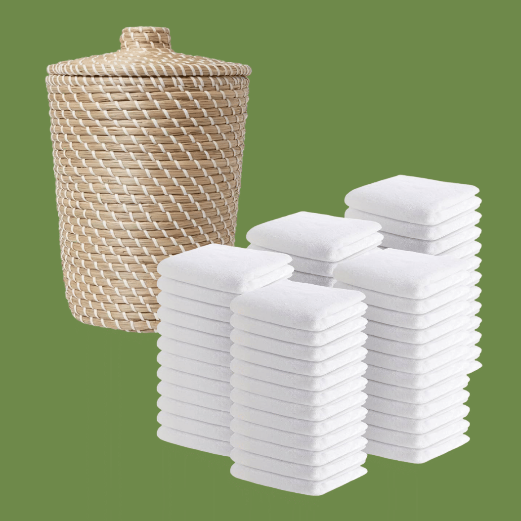 Abundance of white wash cloths + small laundry bin in bathroom