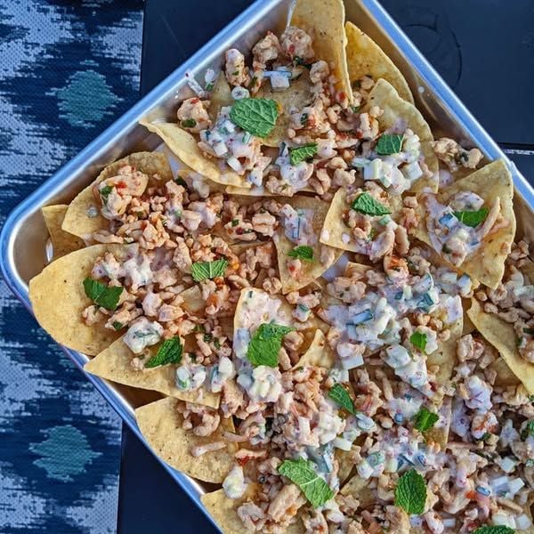leftover chicken from the rotisserie chicken in the frig, shredded on top of crushed tortillas, can of refried beans, generous sprinkling of shredded cheese. broil. top with sour cream, salsa (from the batch of homemade salsa), chopped green onions if I have them.
