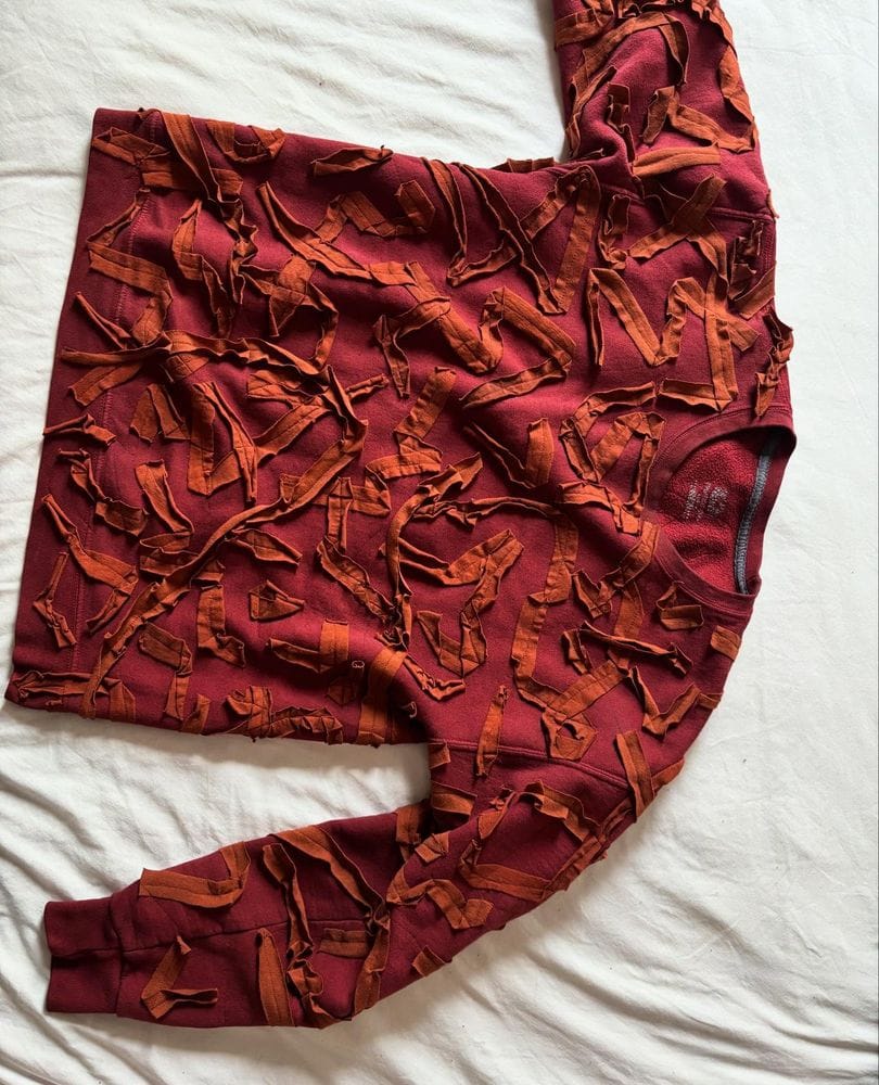 Upcycled sweatshirt with appliqué t-shirt scraps by Tessa Perlow