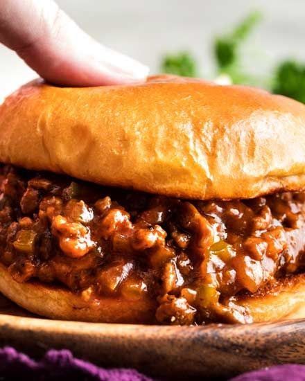 Lowbrow goodness: Sloppy joes. Make a big batch in a Le Crueset, toast the buns with a slice of American cheese on top side, then add a scoop of the meat mixture! Have fed some HUGE family parties this way.