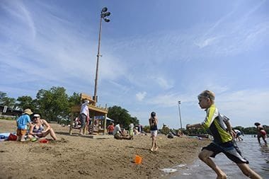take a book to lake nokomis and read on the beach while drinking a beer