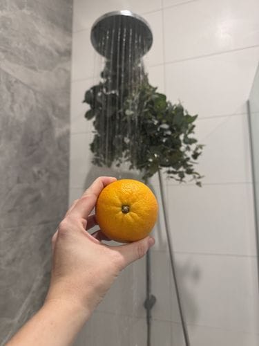 Peeling and eating an orange in the shower