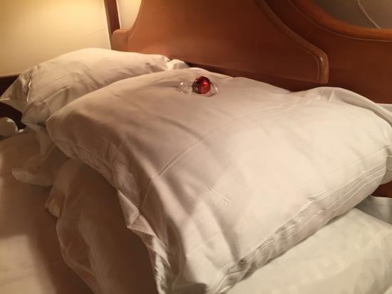 a tiny chocolate on the pillow