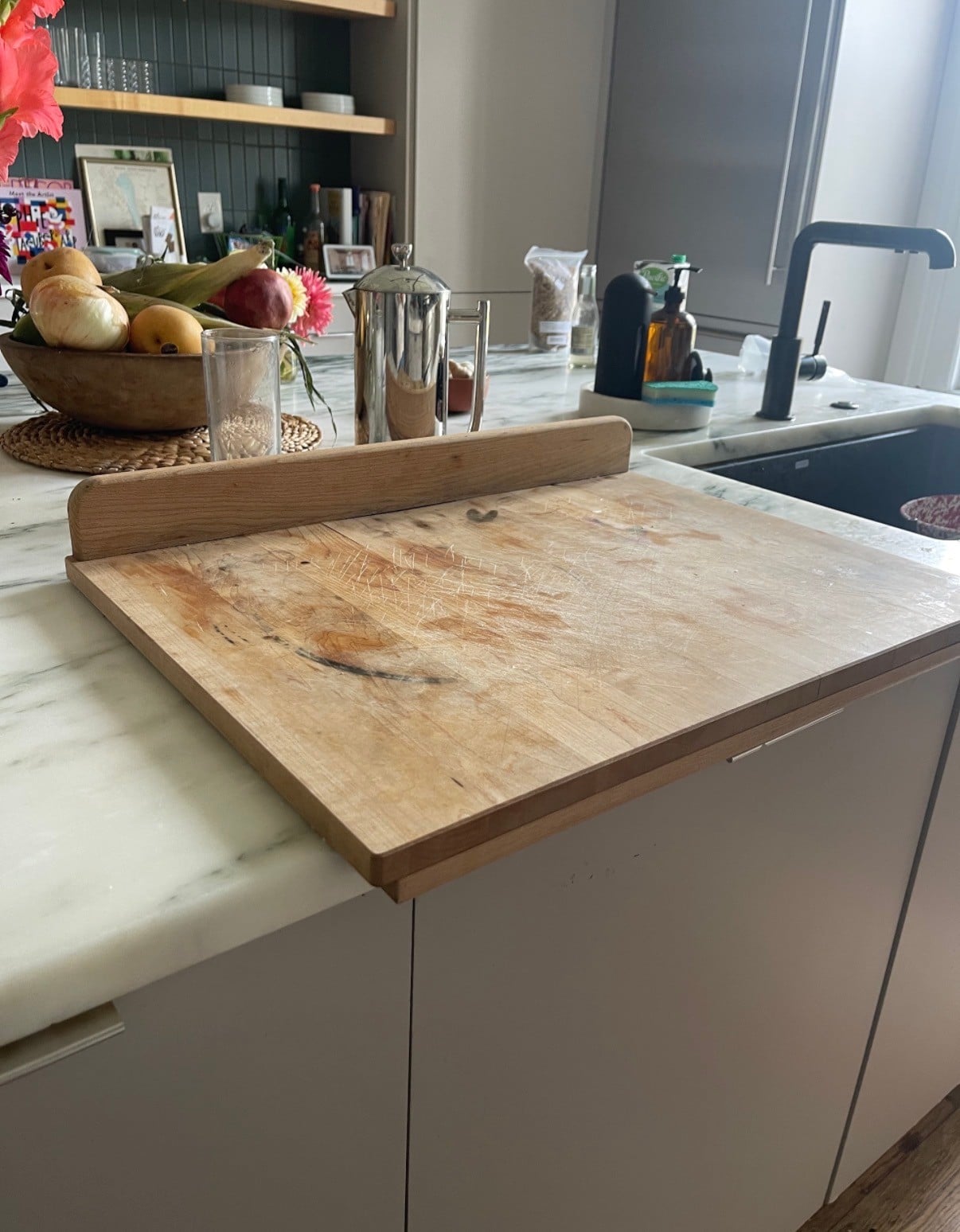 A wood cutting board with a lip that lives on the counter