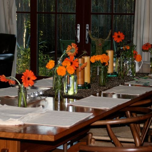 Small bud vases with a few flowers or a sprig of something green scattered around….its a low lift but its whimsical amd fun.