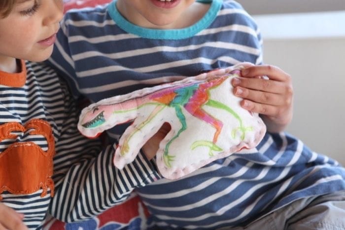 Making your kid draw a creature with fabric markers and then making them sew a pillow from it