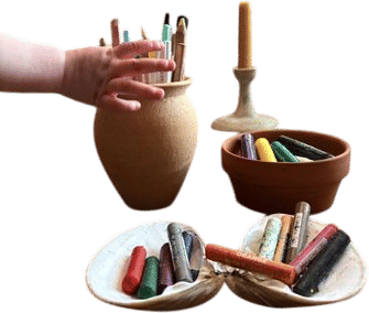 Terracotta pots and seashells to store art supplies.
